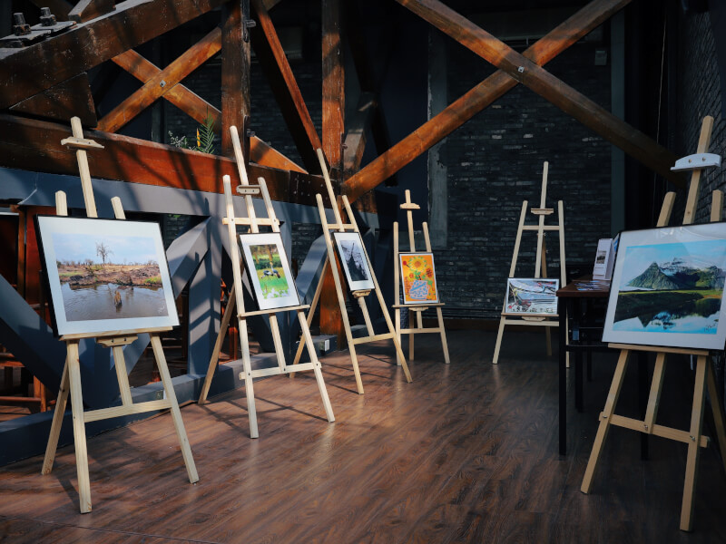 Several easels displaying different paintings